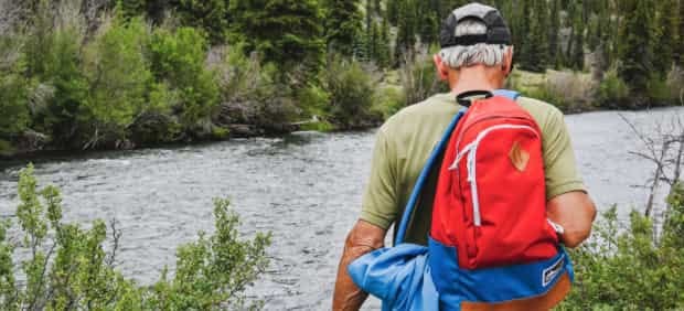 man stands in front of a river wearing red white and blue man stands in front of a river wearing red white and blue