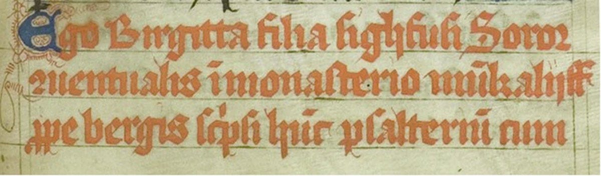 A three-line section from a Medieval manuscript, written in Latin in red ink