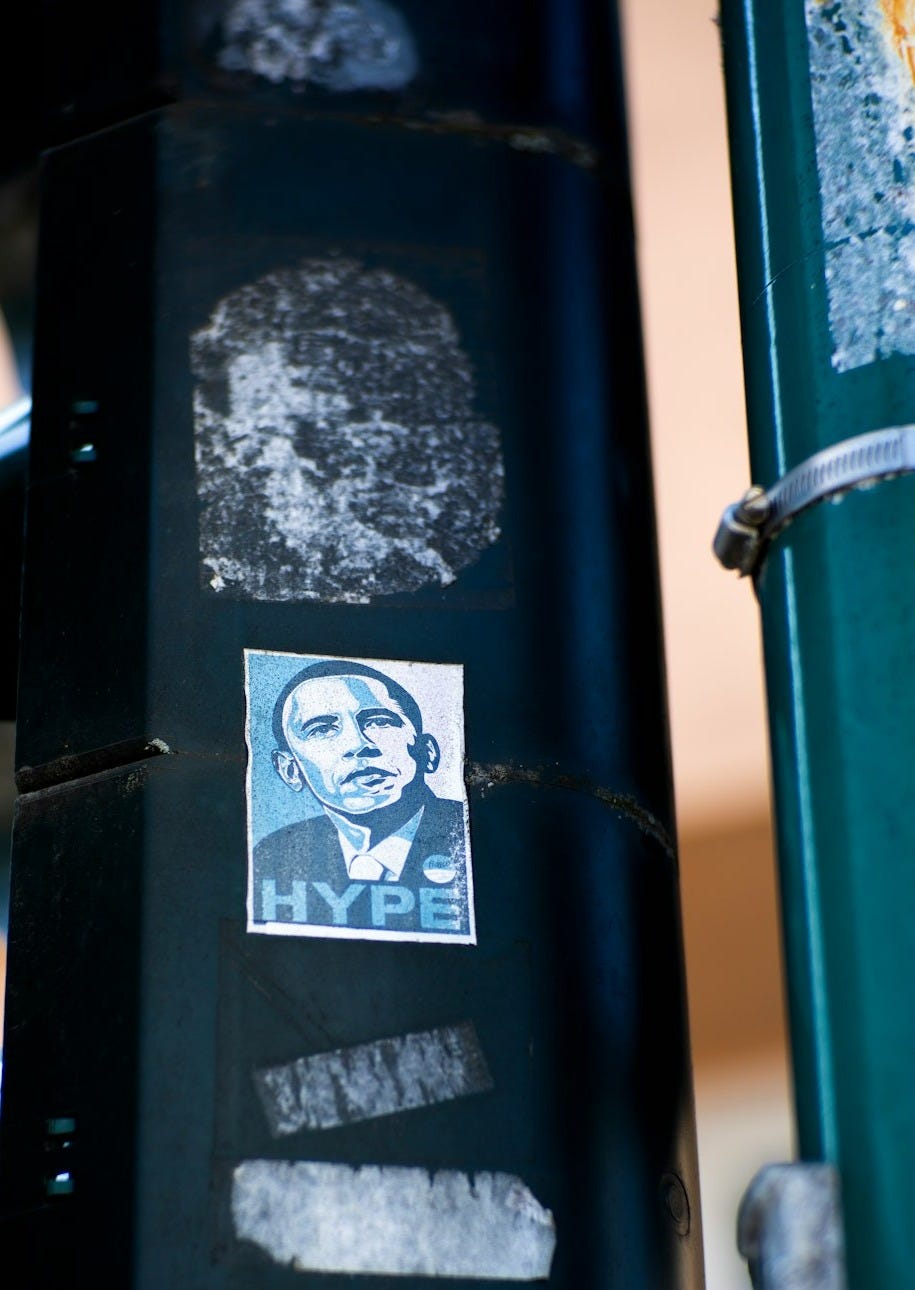 a picture of a man on a sticker on a traffic light a picture of a man on a sticker on a traffic light