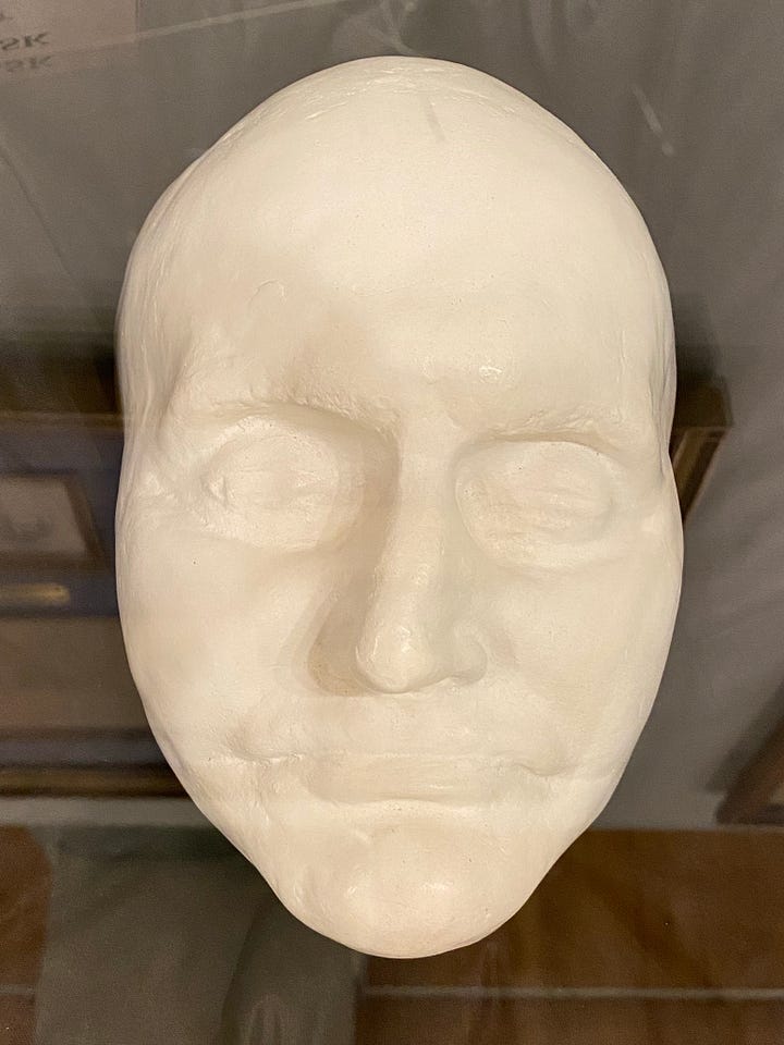 L-R: Museum placard describing the custom of making death masks and a copy of a copy of the original Burr death mask.