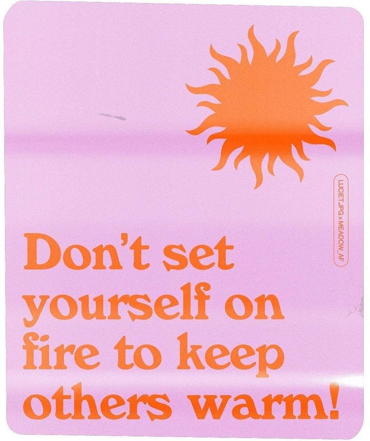 This may contain: an orange and pink sign with the words don't set yourself on fire to keep others warm