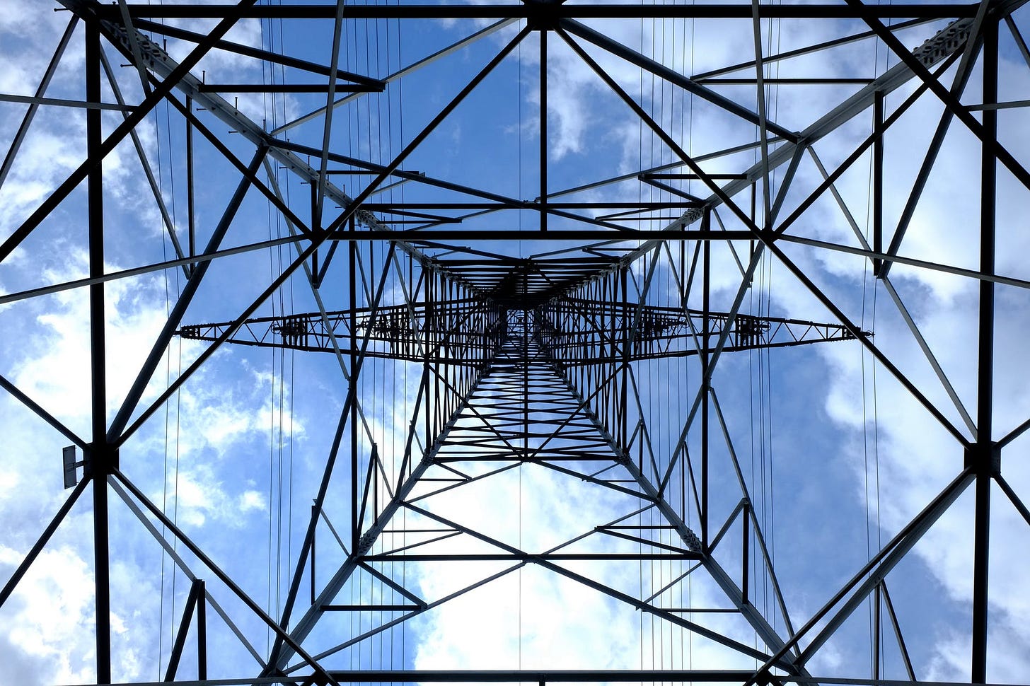 a power grid reaches straight up to a blue sky. Demand for power is high how do we meet our own demand for power? a power grid reaches straight up to a blue sky. Demand for power is high how do we meet our own demand for power?