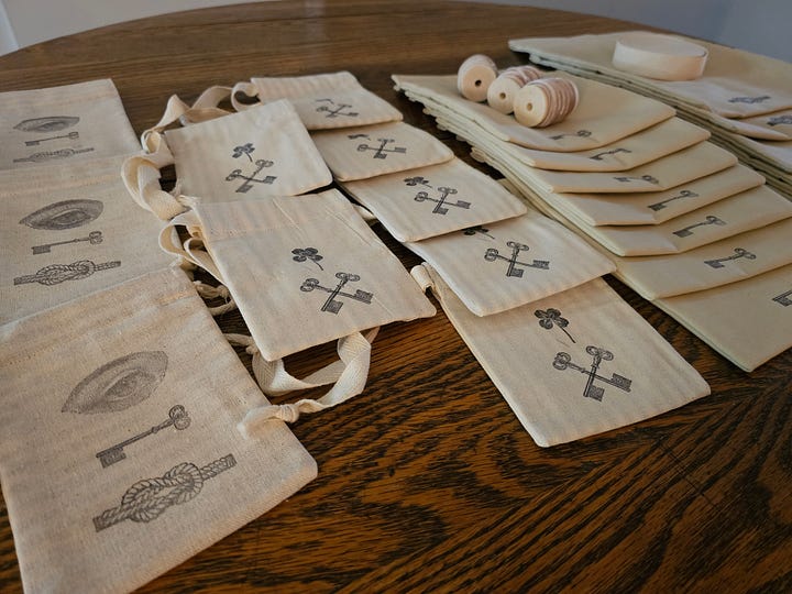 an array of drawstring bags and black ink stamps