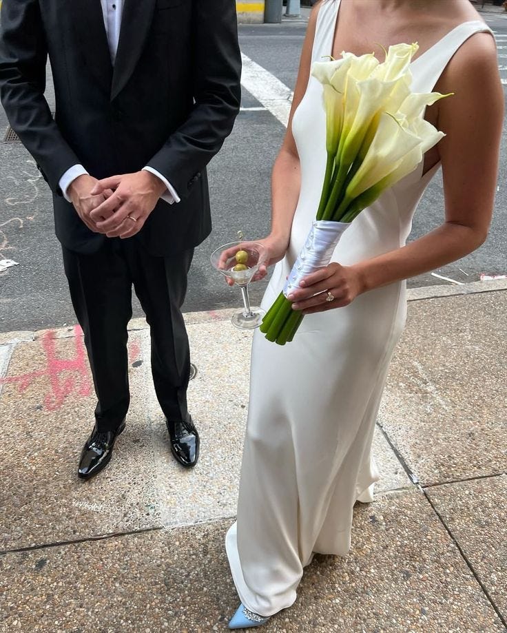 This may contain: a man in a tuxedo standing next to a woman in a white dress
