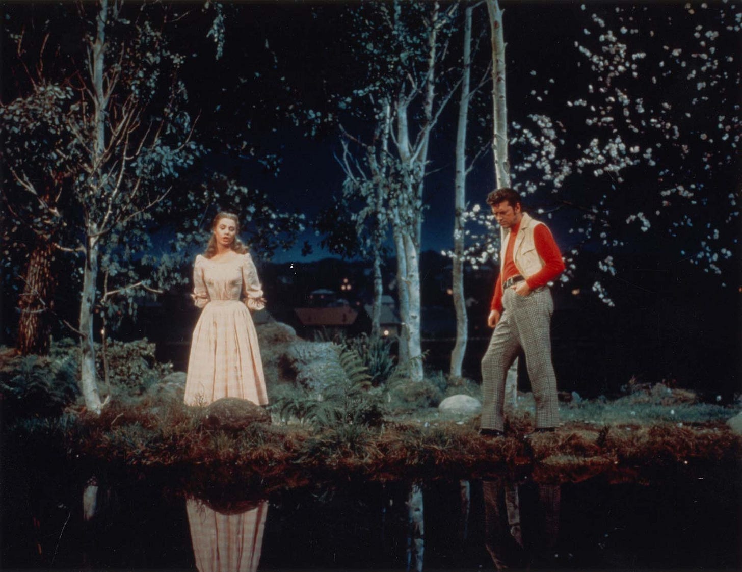 an image from the film adaptation of Carousel; Billy and Julie stand by a pond and sing their duet, "If I Loved You"