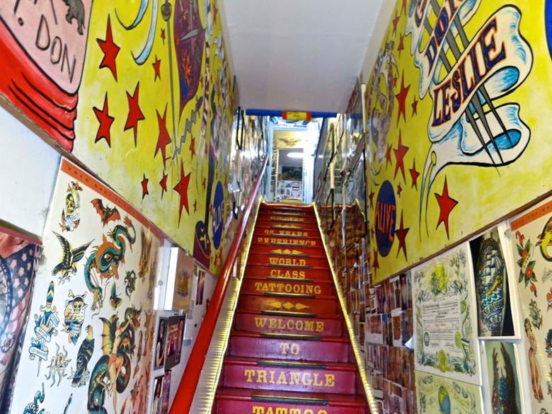 A staircase with red steps and colorful wall art

AI-generated content may be incorrect.