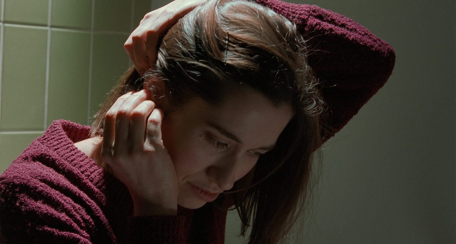 Read My Lips | Still features Emmanuelle Devos as Carla putting on a hearing aid. Read My Lips | Still features Emmanuelle Devos as Carla putting on a hearing aid.