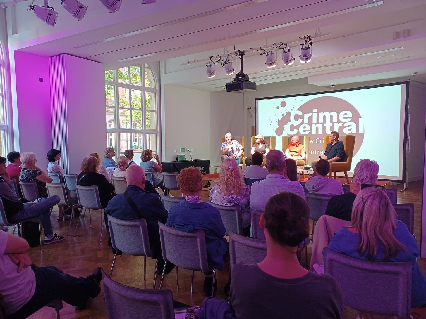 An audience listening to a panel of crime writers at the Crime Central event at Manchester Central Library.