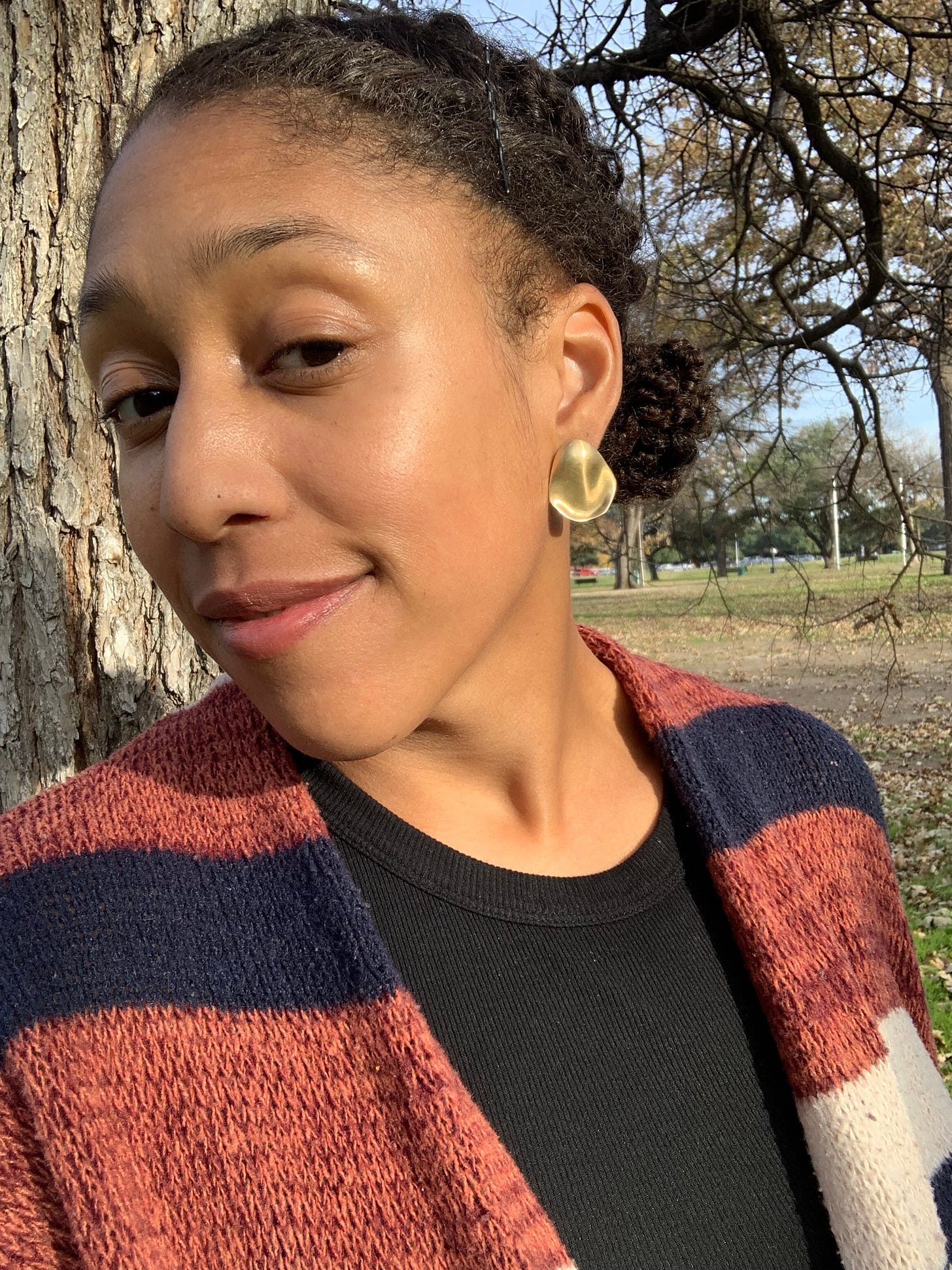 Author Maris Young smiling in front of a tree, contemplating the road to resentment In All Honesty