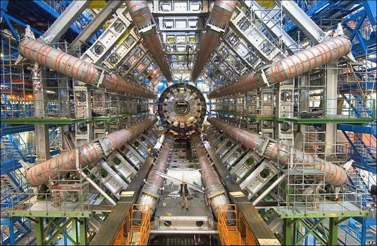 A large array of machinery arranged in a tunnel, as part of a particle detector experiment. A large array of machinery arranged in a tunnel, as part of a particle detector experiment.