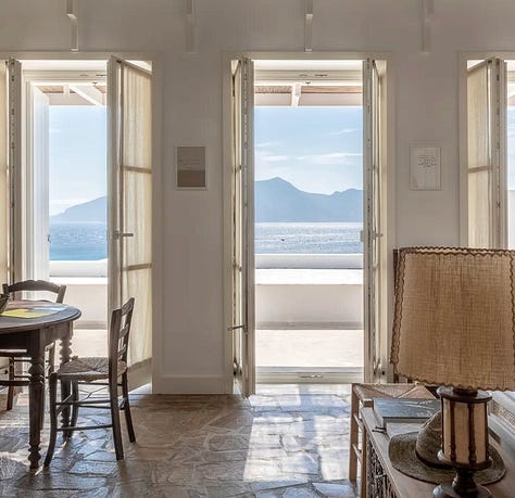 Whitewashed low-rise buildings at Eros Keros, Antiparos, set into a hillside above the Aegean