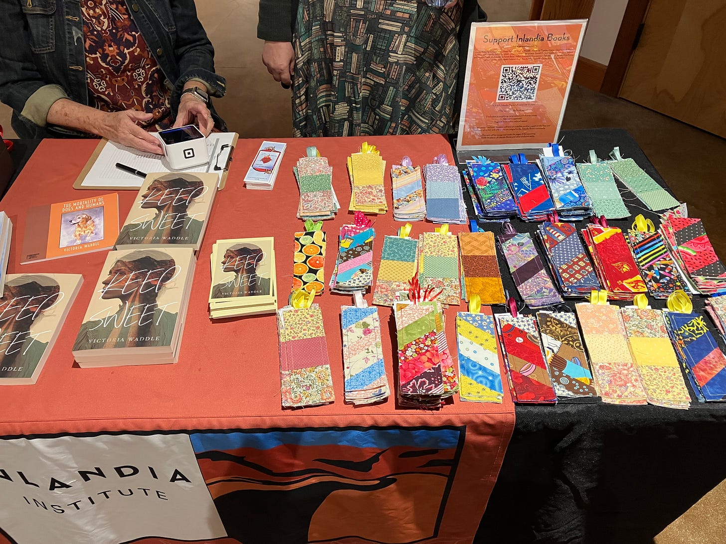 A table with copies of “Keep Sweet” and many fabric bookmarks in various styles and colors. A table with copies of “Keep Sweet” and many fabric bookmarks in various styles and colors.