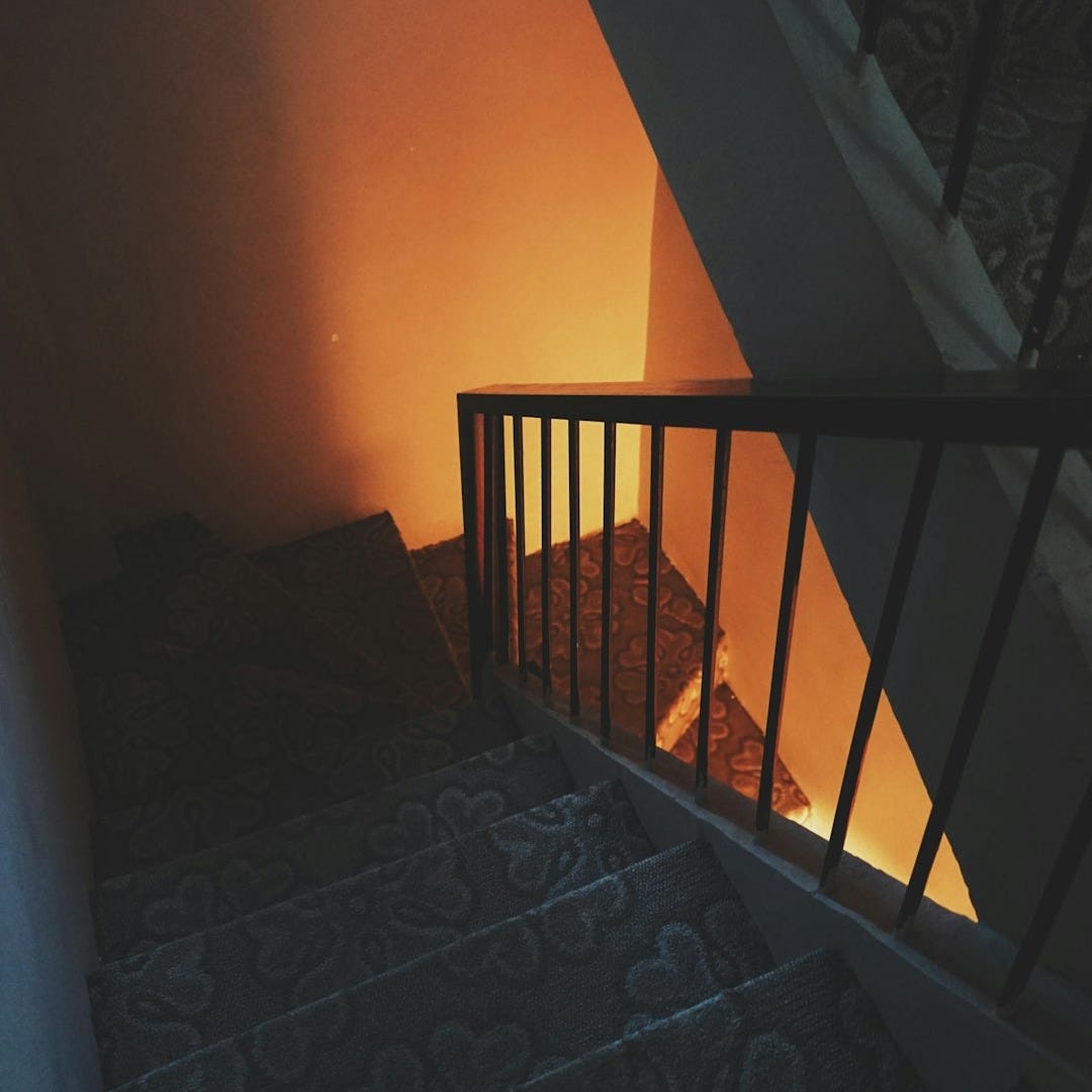a stairway leading up to a window in a house
