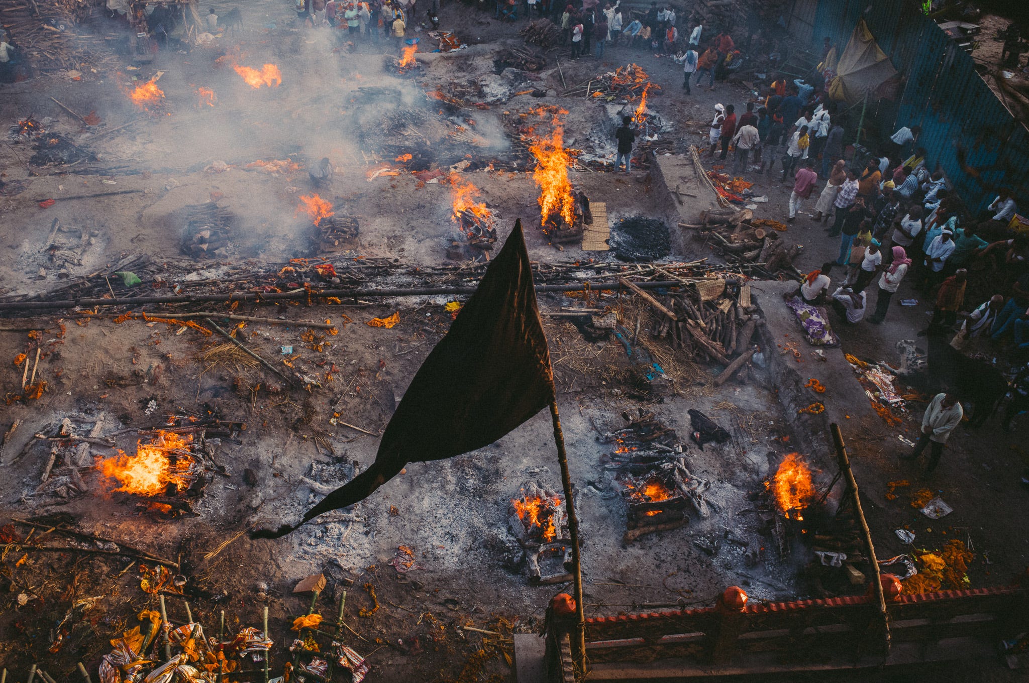 A scene that defines the spirit, the Hindu flag standing tall, symbolising the eternal rhythm of the city, rising from the burning ghats of Manikarnika Ghat.