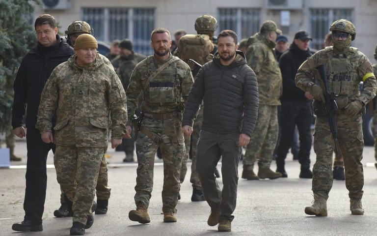 Mandatory Credit: Photo by OLEG PETRASYUK/EPA-EFE/Shutterstock (13622404d) Ukrainian President Volodymyr Zelensky (4-L, front) visits the recaptured city of Kherson, Ukraine, 14 November 2022. Ukrainian troops entered Kherson on 11 November after Russian troops had withdrawn from the city. Kherson was captured in the early stage of the conflict, shortly after Russian troops had entered Ukraine in February 2022. Ukraine's President Zelensky visits recaptured city of Kherson - 14 Nov 2022 - OLEG PETRASYUK/EPA-EFE/Shutterstock 