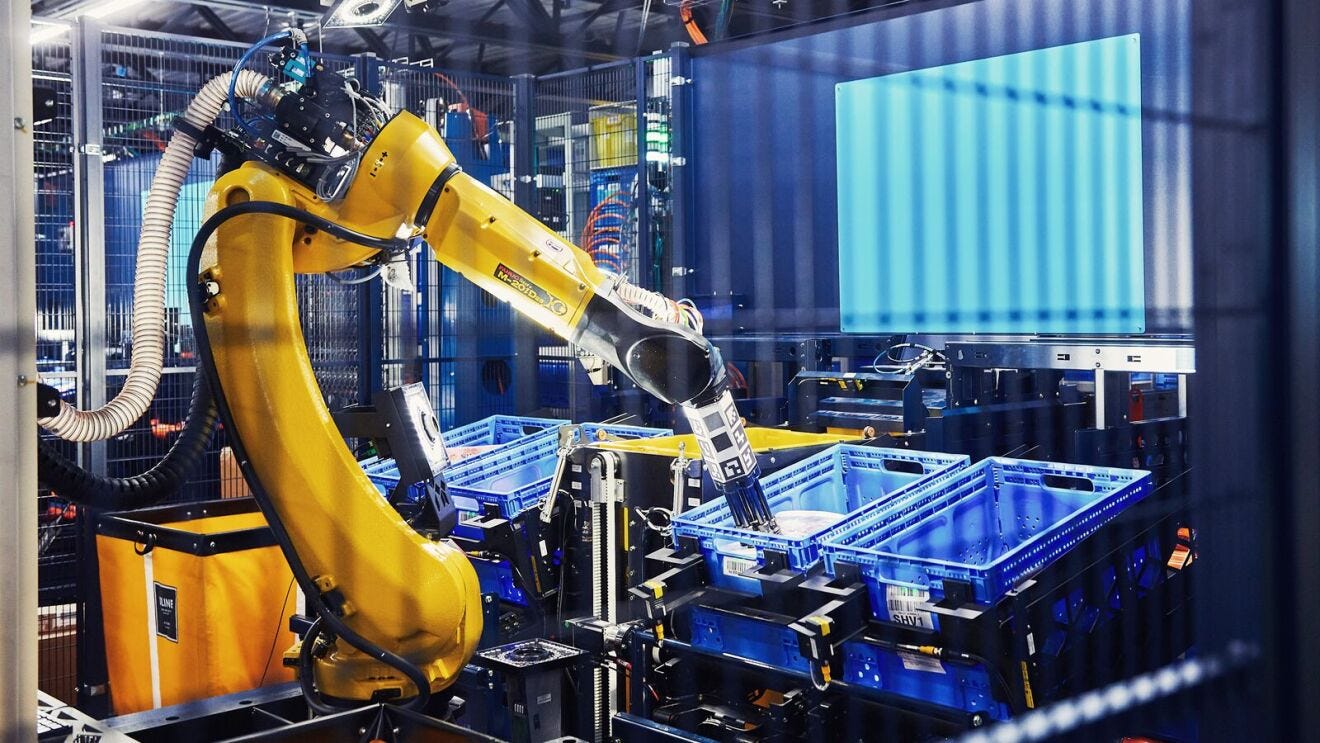 An Amazon robotic arm moves inventory at a fulfillment center.