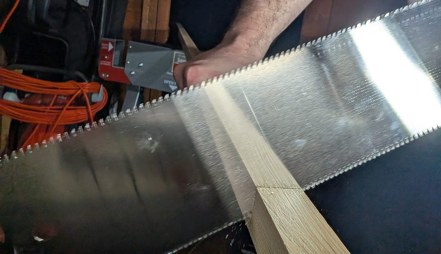 double-sided saw blade at an angle cutting a piece of wood