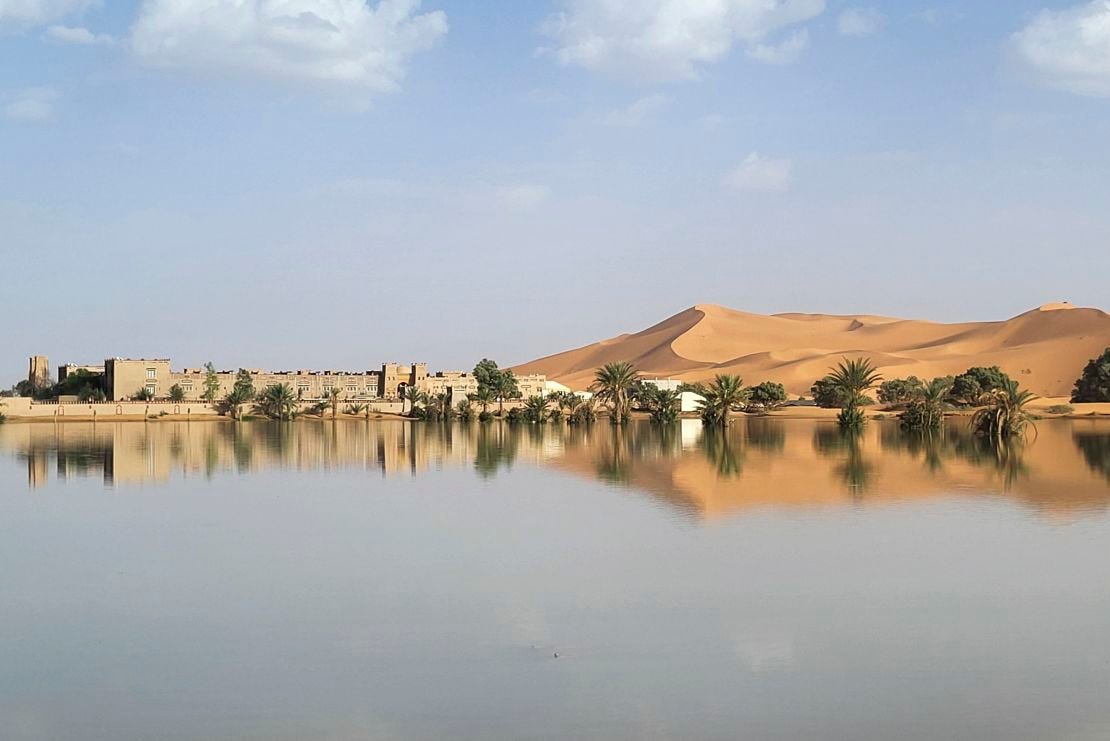 Buildings along a lake filled by heavy rainfall in the desert town of Merzouga on October 2, 2024.