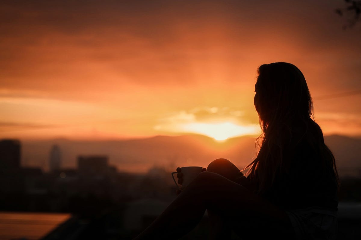 Person watching sunrise Person watching sunrise