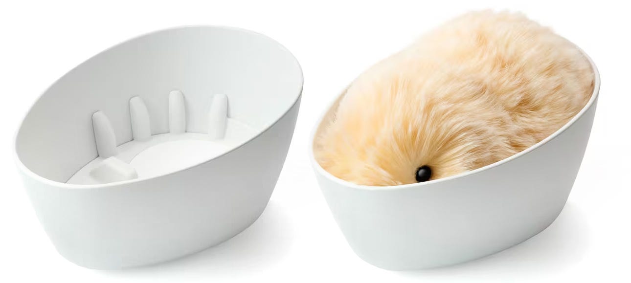 The Casio Moflin robotic pet placed inside its charging bowl.