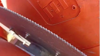 A close up of a saw

Description automatically generated