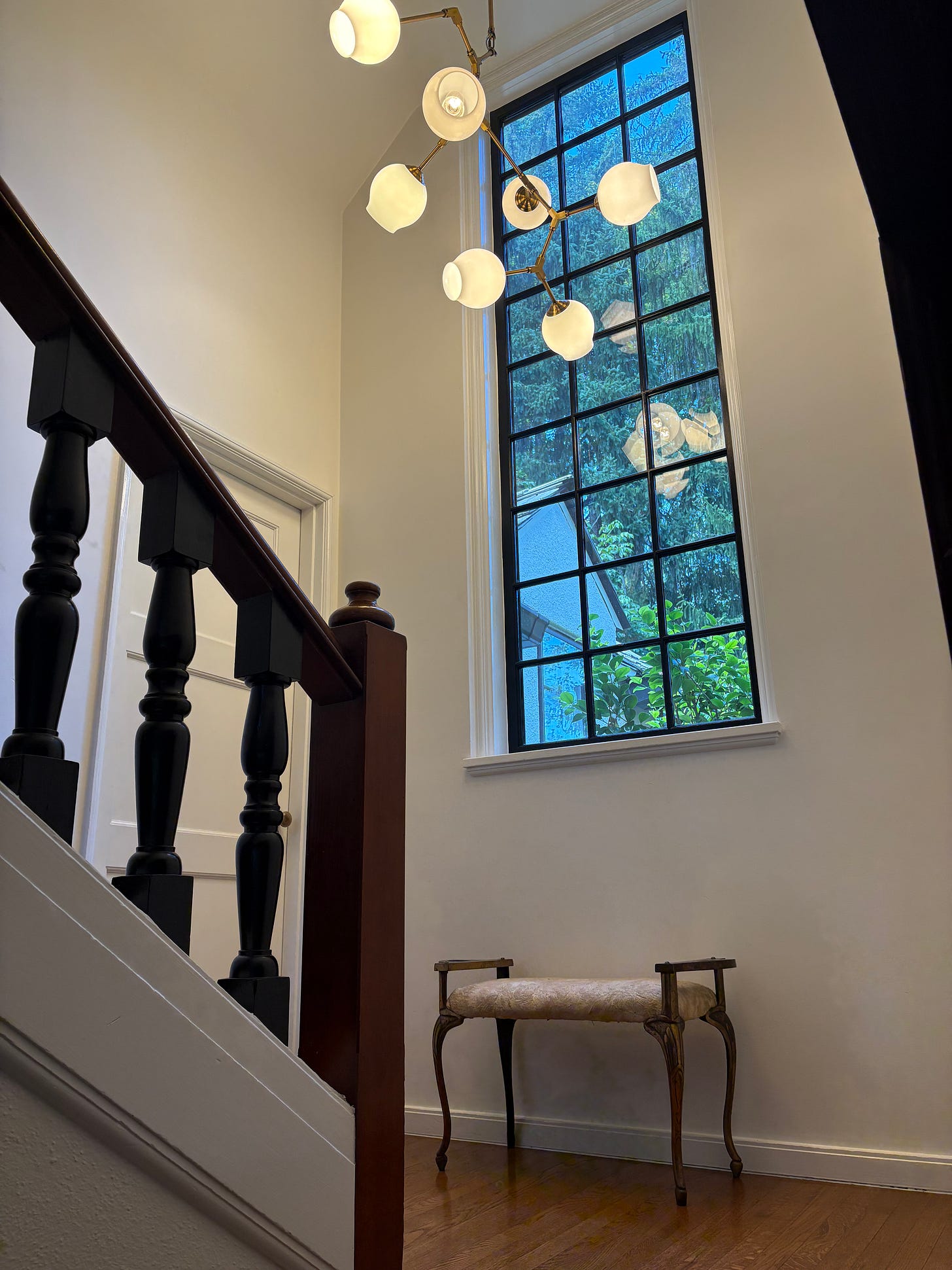 stairwell, entryway, bench, metal bench, metal, railing, recover bench, upholstery, light fixture, Tudor home, Lake Oswego, interior design, interior designers, hgtv