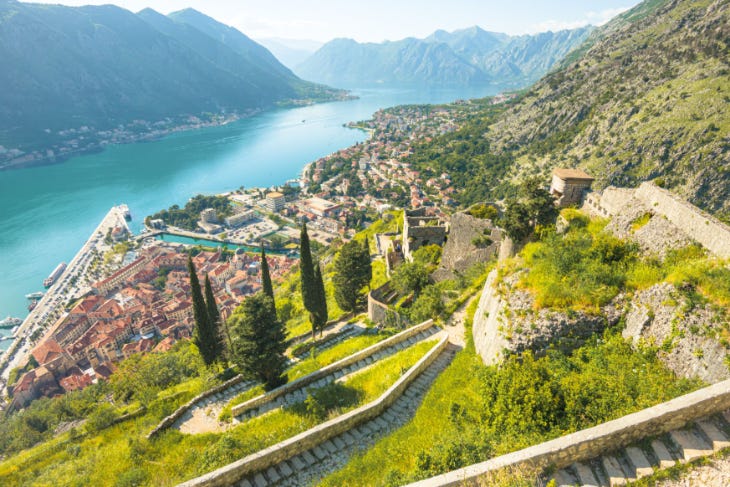 A beautiful view of a small town on the edge of a lake or fjord A beautiful view of a small town on the edge of a lake or fjord