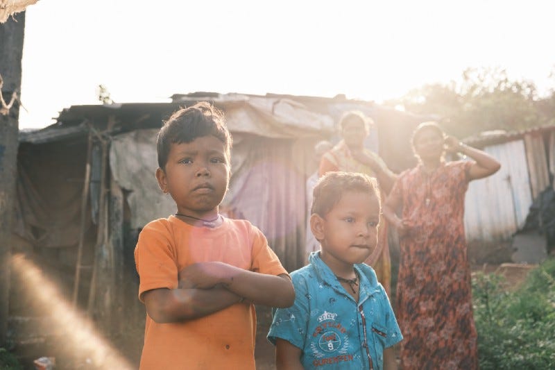 Two young Indian boys in an Indian slum looking into the camera Two young Indian boys in an Indian slum looking into the camera