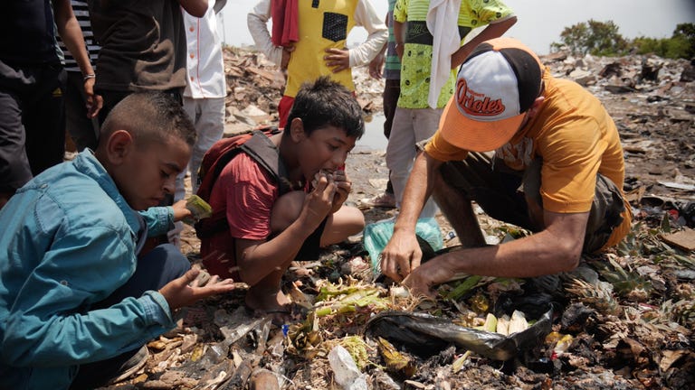 Children looking through rubbish for food in Maracaibo