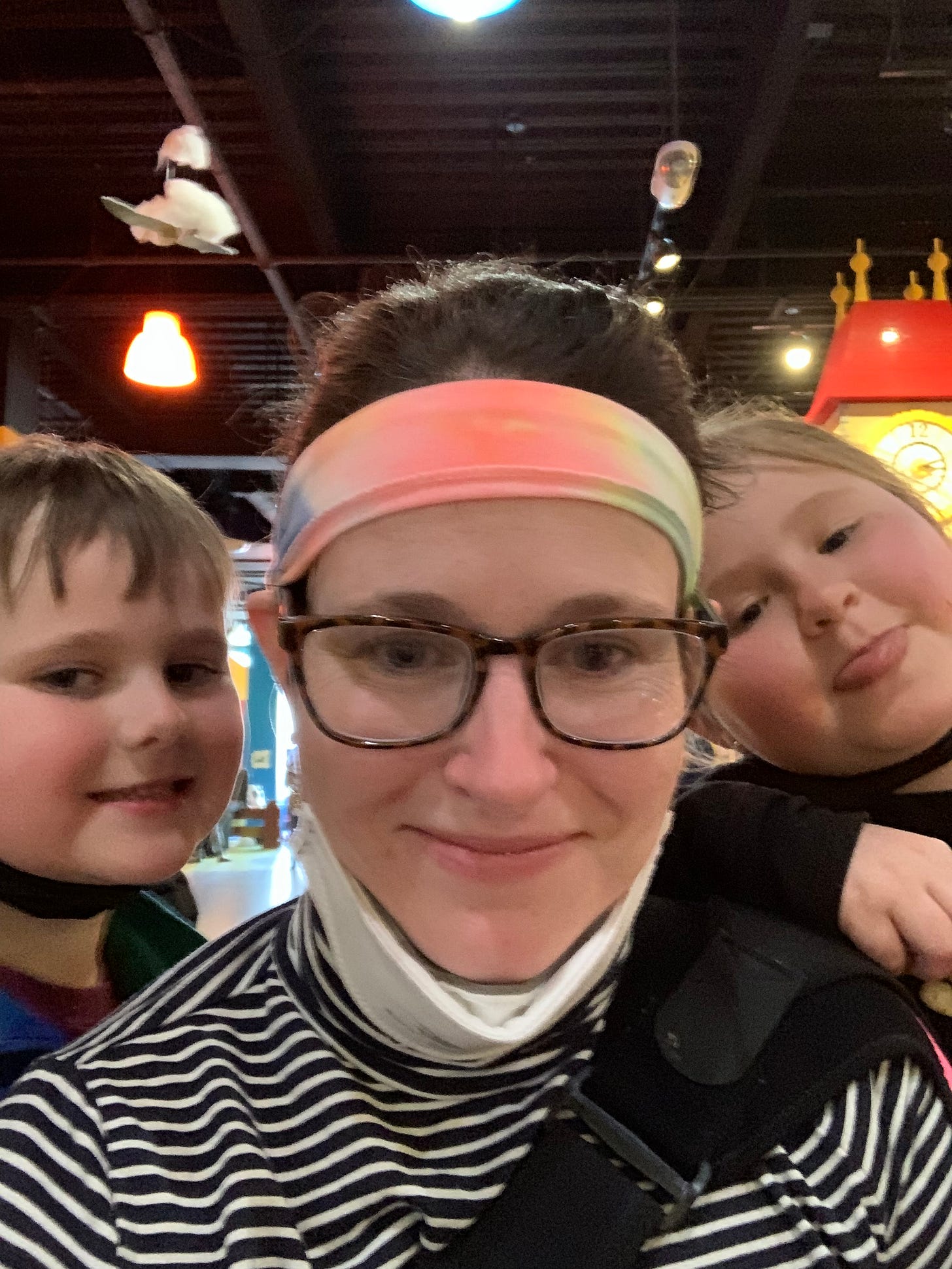 White woman in center with her two elementary age kids