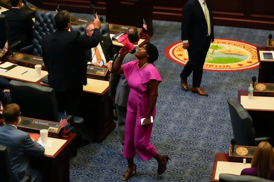 State Rep. Angie Nixon, D-Jacksonville, shouts through a megaphone on the House floor in protest of a vote on a redistricting bill during a special session of the Legislature, Wednesday, April 29, 2026, in Tallahassee. The House Rules and Ethics Committee later reprimanded Nixon for the disruption. State Rep. Angie Nixon, D-Jacksonville, shouts through a megaphone on the House floor in protest of a vote on a redistricting bill during a special session of the Legislature, Wednesday, April 29, 2026, in Tallahassee. The House Rules and Ethics Committee later reprimanded Nixon for the disruption.