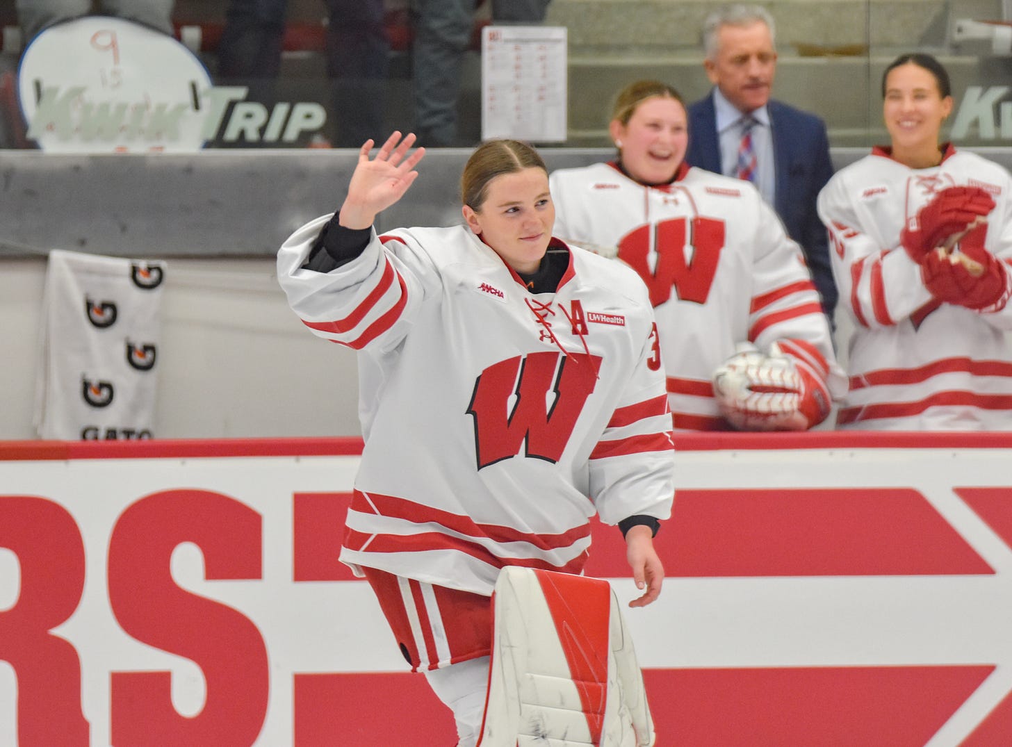 Goaltender Ava McNaughton waves her right hand as she skates onto the ice while being introduced by the public address announcer
