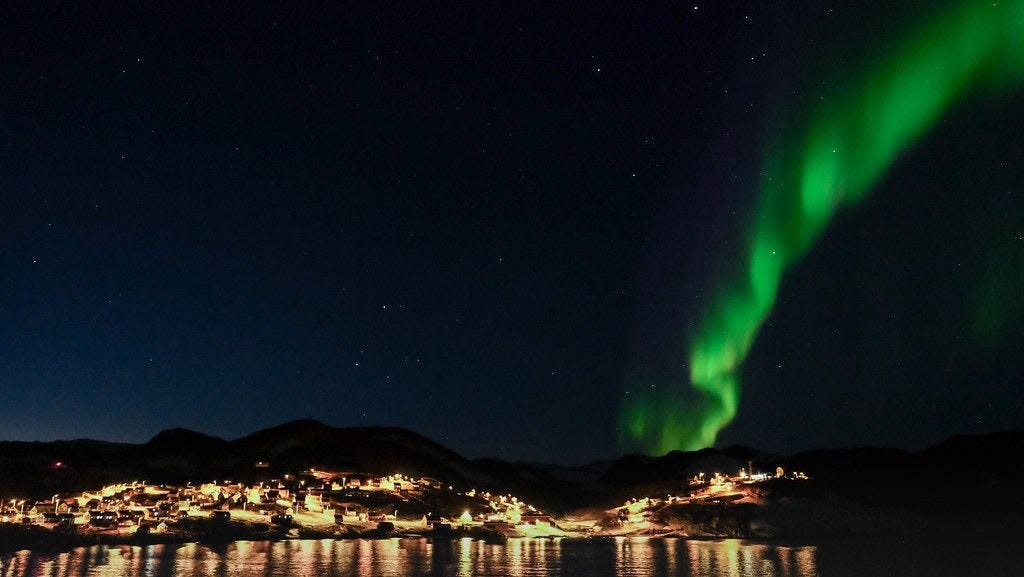The Northern Lights dancing above Ittoqqortoormiit in East Greenland The Northern Lights dancing above Ittoqqortoormiit in East Greenland