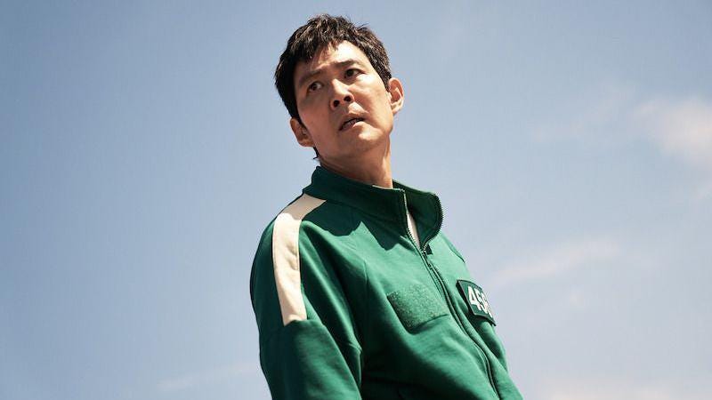 Lee Jung-jae as Gi-hun, wearing a green tracksuit against a blue background Lee Jung-jae as Gi-hun, wearing a green tracksuit against a blue background