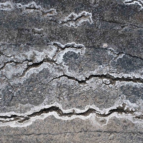 Three black and white abstraction photographs of clouds, water and lines on pavement.