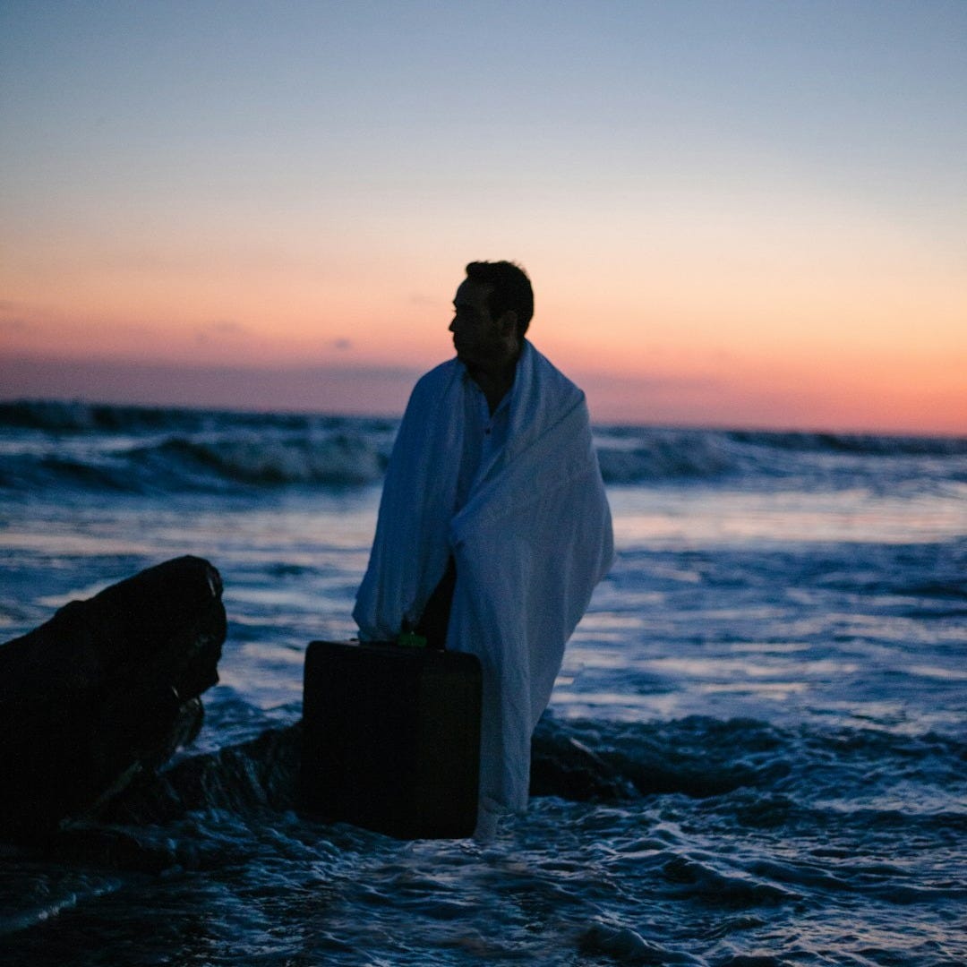 man standing in body of water man standing in body of water