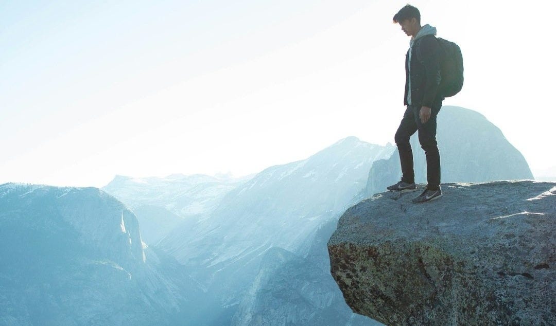 man standing on cliff