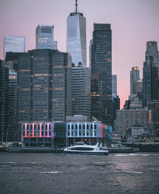 May be an image of boat, skyscraper and the Brooklyn Bridge