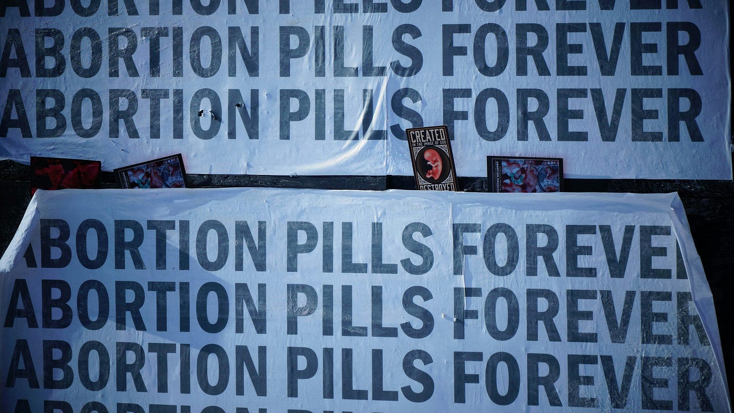 Placards and signs advertising chemical abortion pills