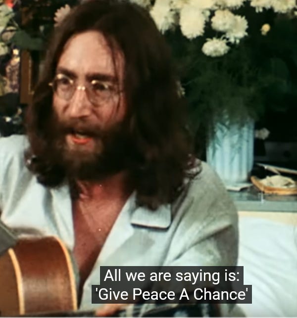 John Lennon sings give peace a chance.