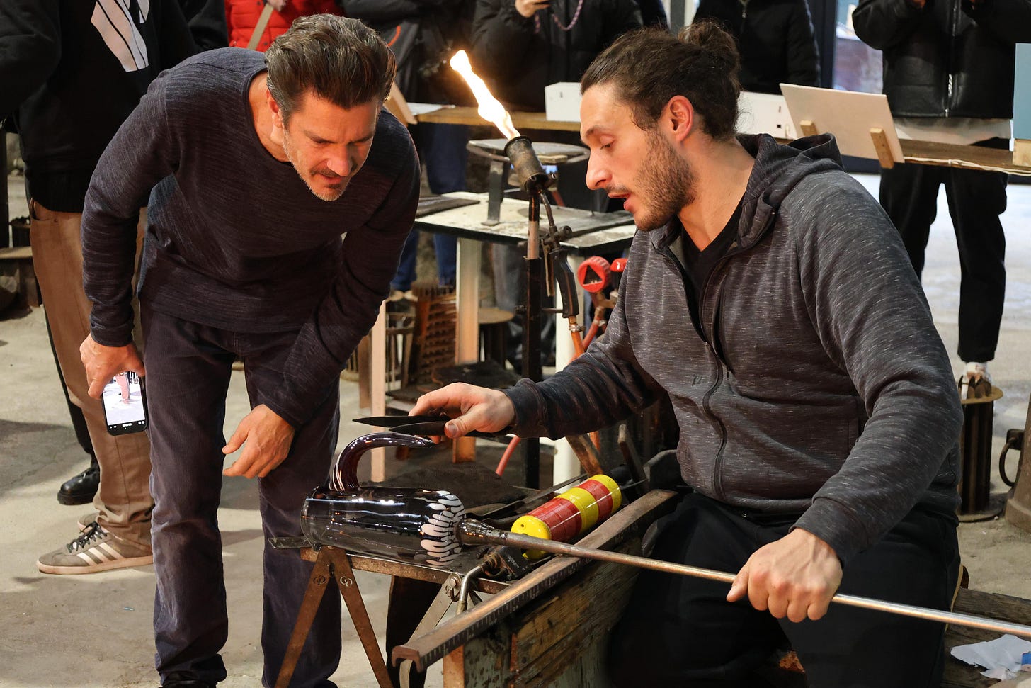 Armand Louis and Maestro Roberto at the glassworking bench of the Wave Murano Glass furnace Armand Louis and Maestro Roberto at the glassworking bench of the Wave Murano Glass furnace