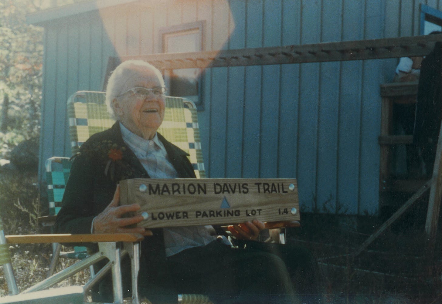 Marion Davis holding a trail sign