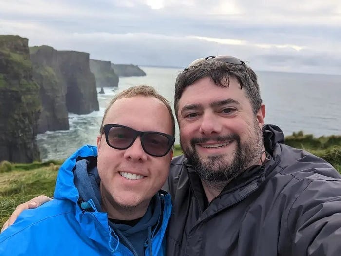 The author and his husband pose for a photo at the Cliffs of Moher in Ireland.