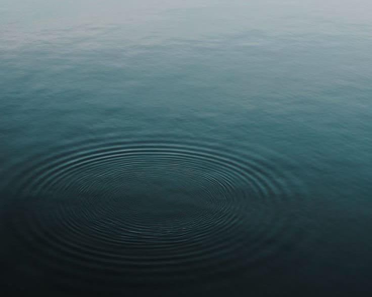 This may contain: a large body of water with ripples in it