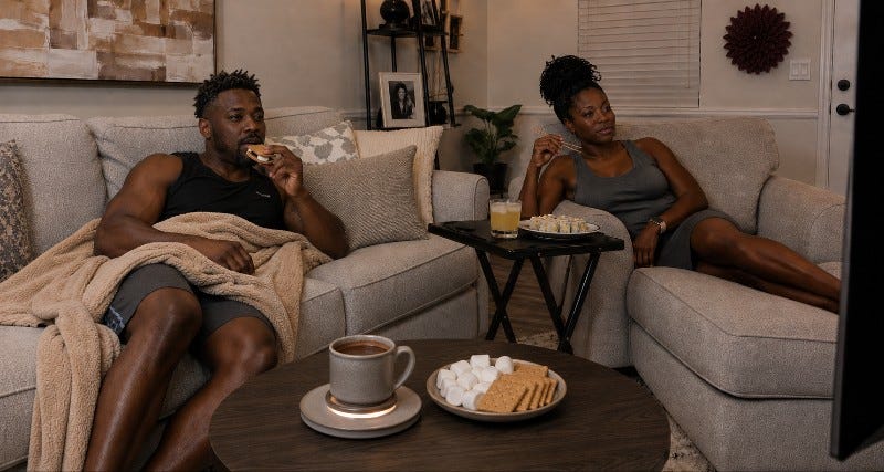Two people relax while watching TV, eating California rolls, s'mores and a whiskey sour. Two people relax while watching TV, eating California rolls, s'mores and a whiskey sour.