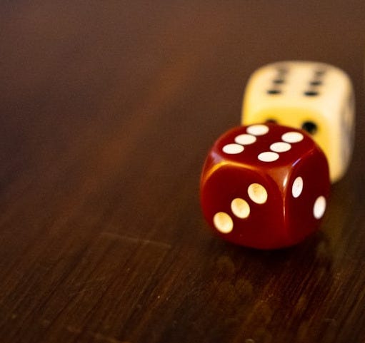 seven white and red dices on brown wooden table
