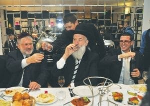Ukrainian billionaire and Jewish philanthropist Igor Kolomoisky (left), raises a vodka toast with Israeli Chief Rabbi Yona Metzger, drinking, at Berlin’s Chabad center during a conference of the European Council of Jewish Communities. JTA photo by Berlin Chabad.
