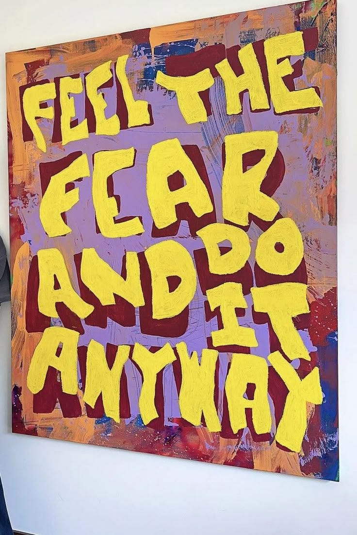 This may contain: a woman standing in front of a painting that says feel the fear and do it anyway This may contain: a woman standing in front of a painting that says feel the fear and do it anyway
