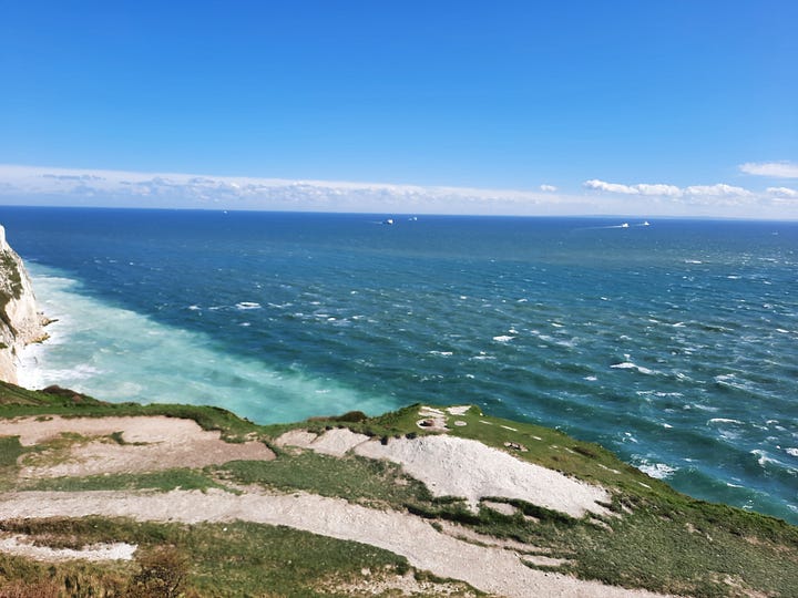Images of fields, mountain lake, and ocean cliffs