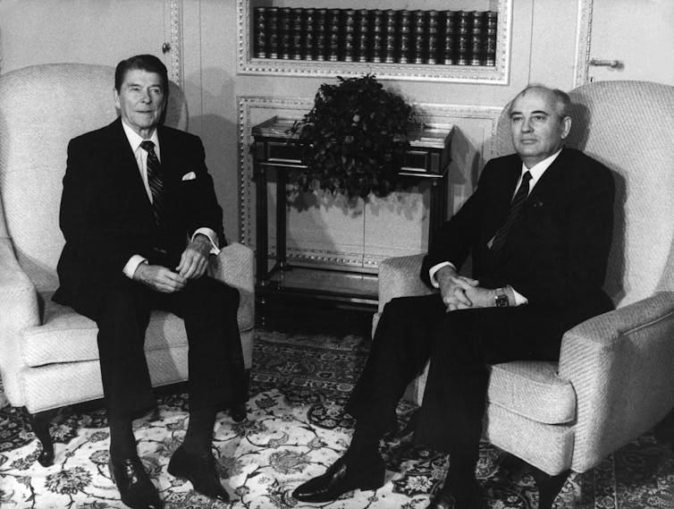 US president Ronald Reagan and Russian leader Mikhail Gorbachev sitting in armchairs. US president Ronald Reagan and Russian leader Mikhail Gorbachev sitting in armchairs.